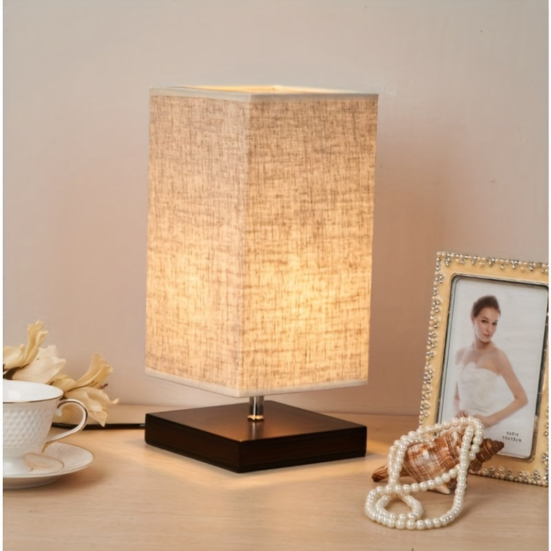A Compact Table Lamp for The Bedroom, Featuring a Straightforward Design with a Square Fabric Shade. This Desk Lamp Is Suitable for Reading And Can Be Used in Bedrooms, Living Rooms, Offices