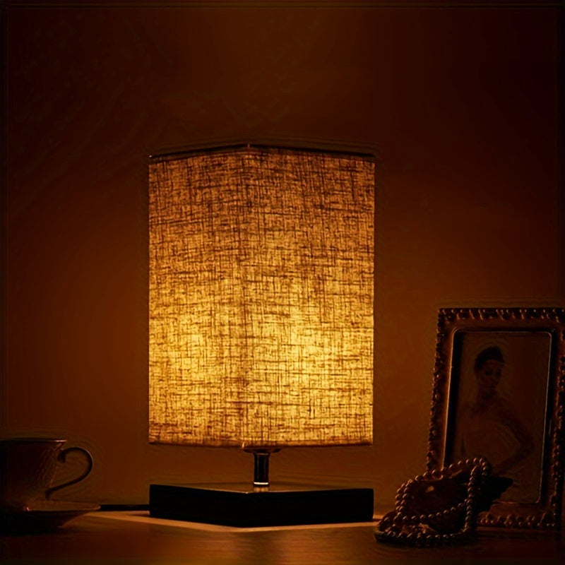A Compact Table Lamp for The Bedroom, Featuring a Straightforward Design with a Square Fabric Shade. This Desk Lamp Is Suitable for Reading And Can Be Used in Bedrooms, Living Rooms, Offices