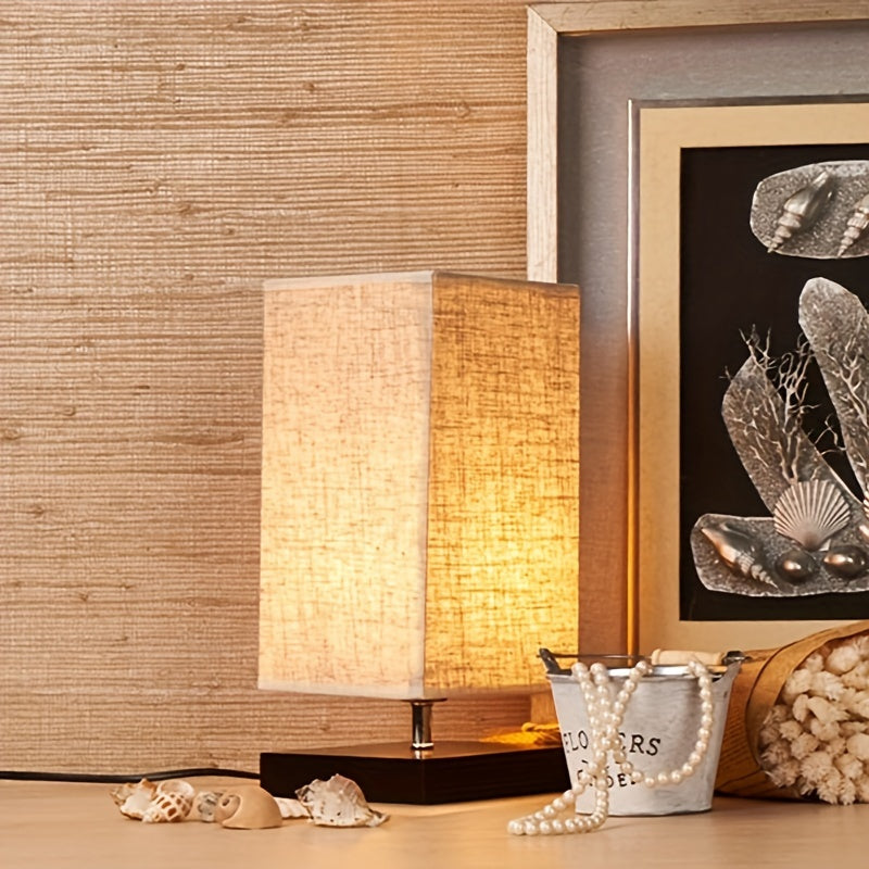 A Compact Table Lamp for The Bedroom, Featuring a Straightforward Design with a Square Fabric Shade. This Desk Lamp Is Suitable for Reading And Can Be Used in Bedrooms, Living Rooms, Offices
