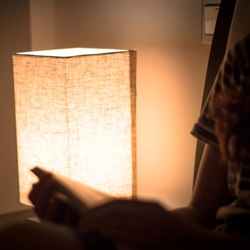 A Compact Table Lamp for The Bedroom, Featuring a Straightforward Design with a Square Fabric Shade. This Desk Lamp Is Suitable for Reading And Can Be Used in Bedrooms, Living Rooms, Offices